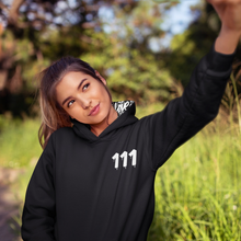 Load image into Gallery viewer, Black hoodie with 111 Angel Number design from Angel Numbers Merch Official, symbolizing new beginnings &amp; manifestation.
